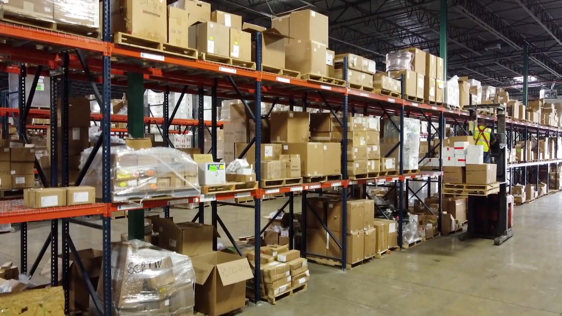 A warehouse worker picking cartons for fulfillment