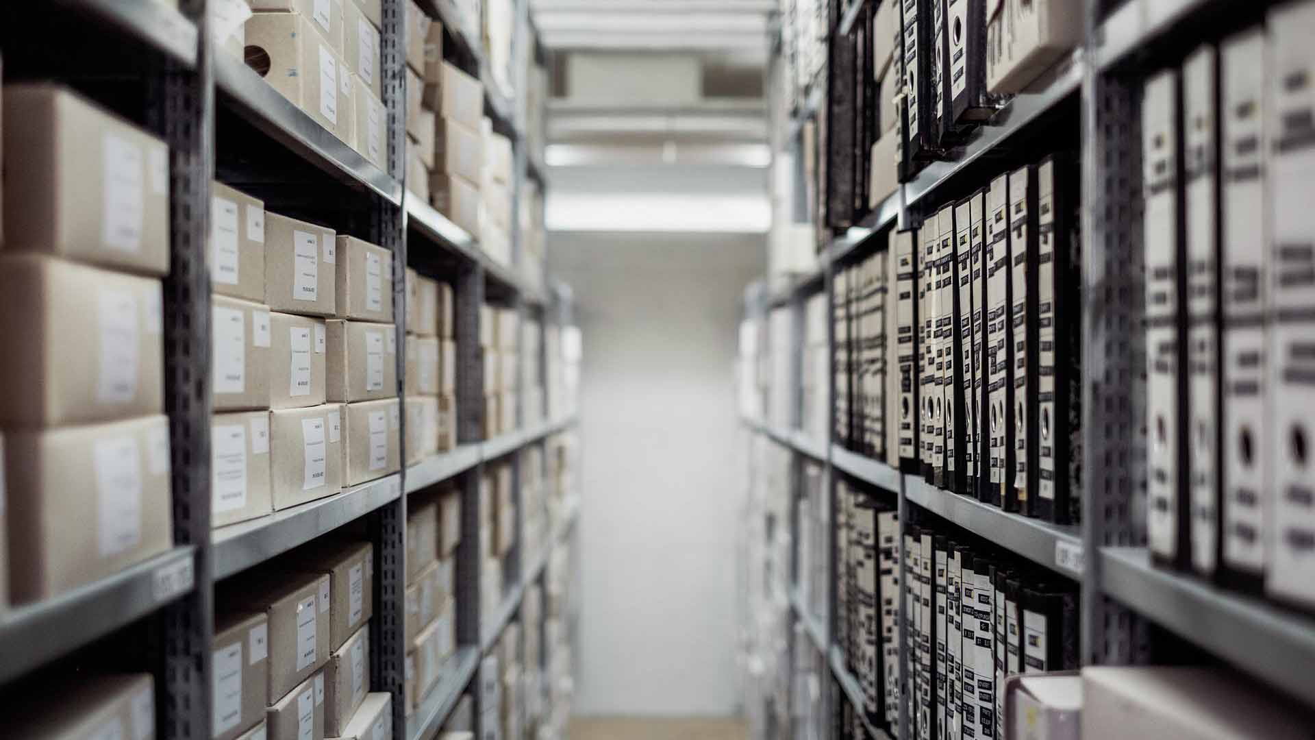 A government warehouse with archives of files on shelving