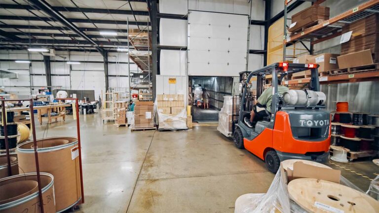 A forklift offloading material from a truck