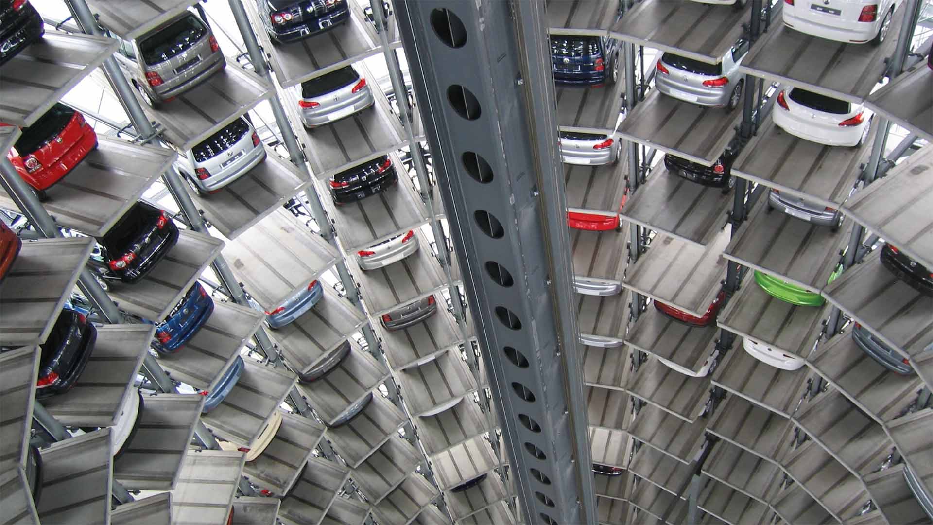 A large multi level, cylindrical parking garage with automated machine picking of cars.