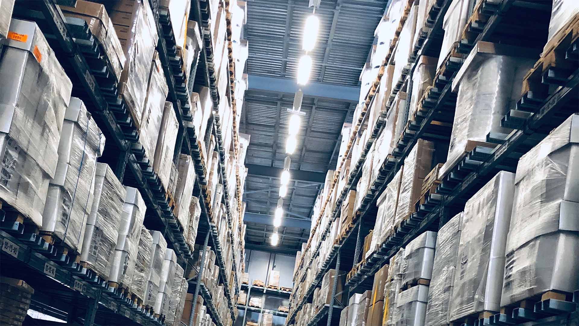 A tall warehouse loaded with pallets from floor to ceiling.