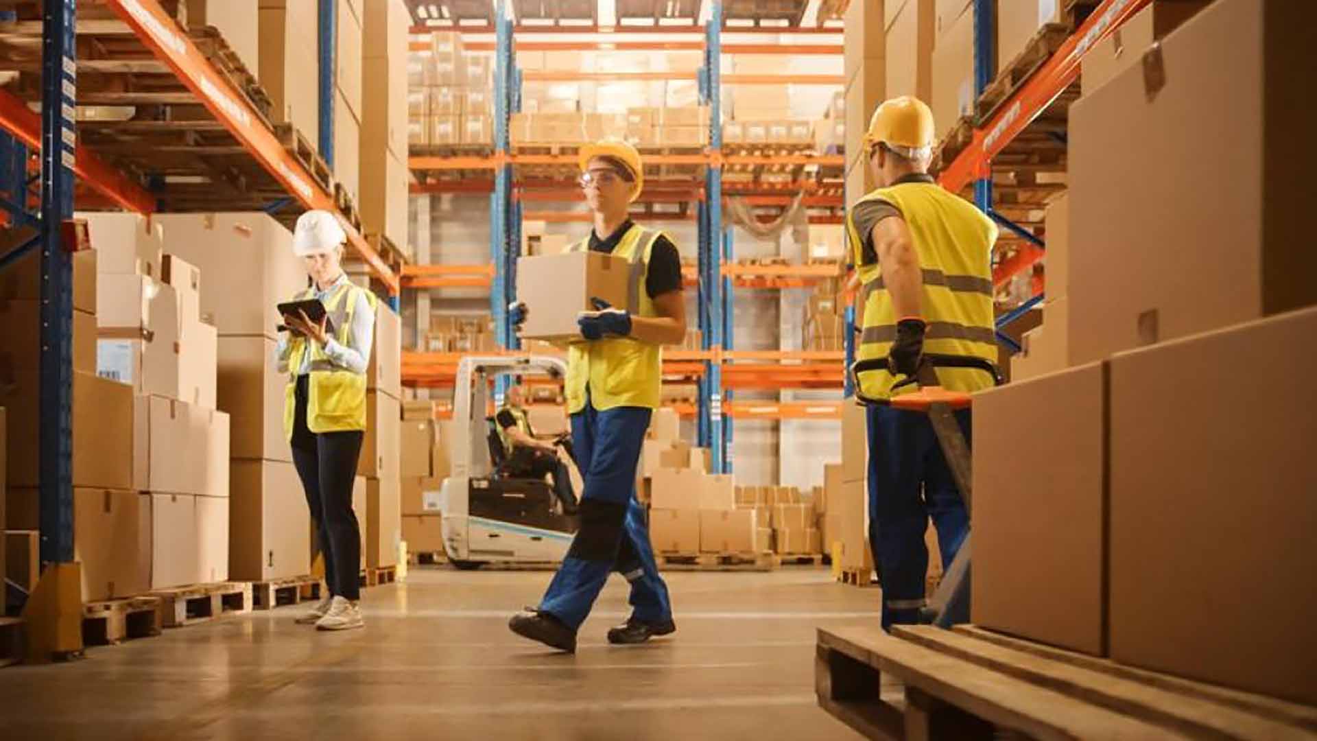 group of warehouse pickers moving boxes