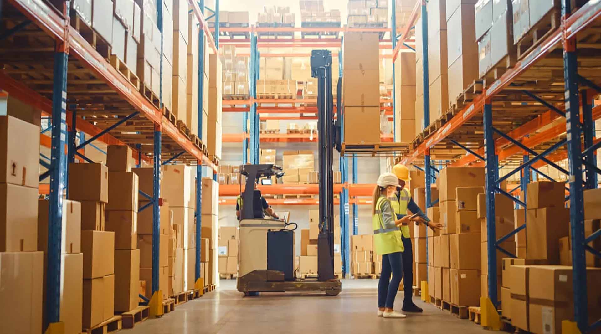 warehouse pickers using a forklift to move a pallet and inspecting other materials