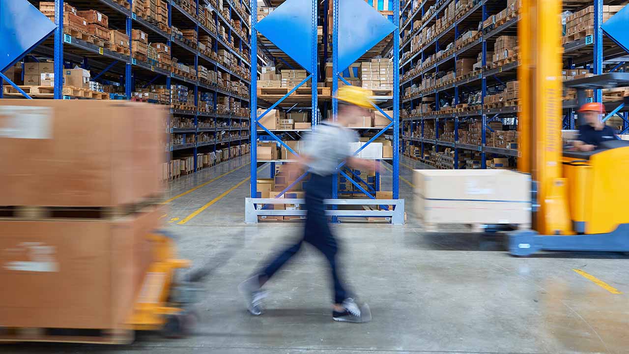 A fast moving warehouse with forklift and pallet jack