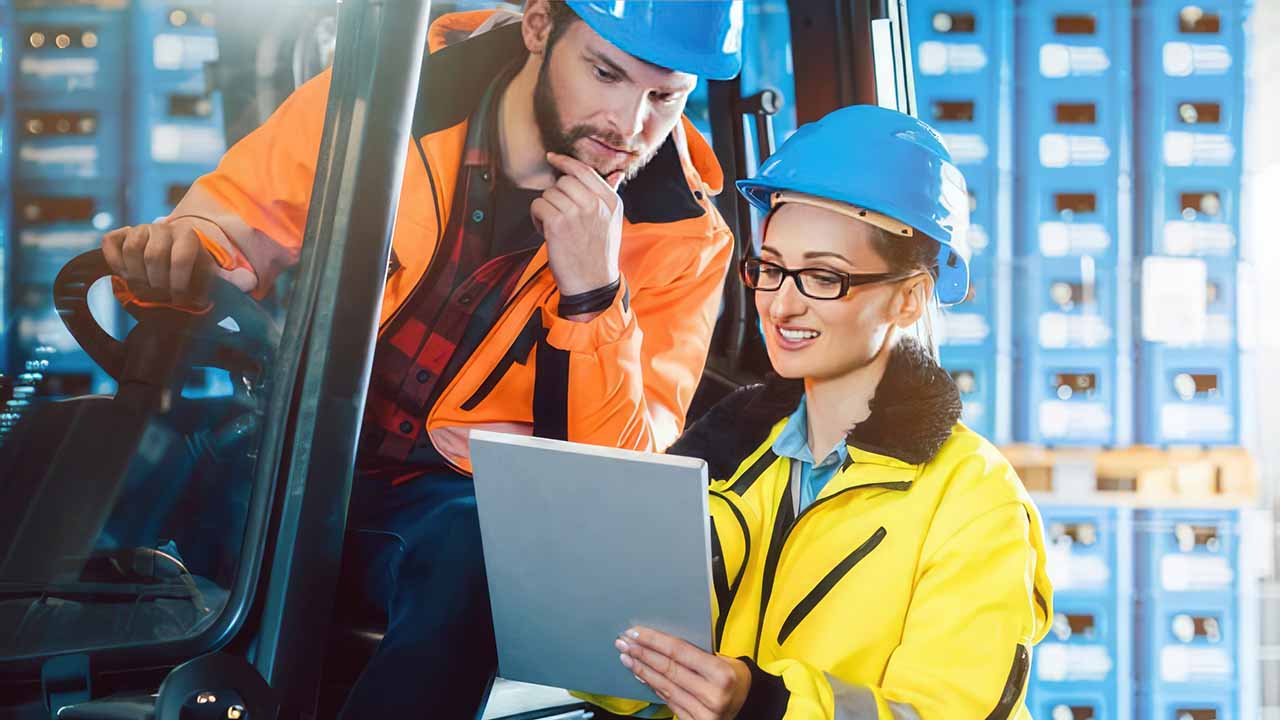 warehouse workers reviewing data