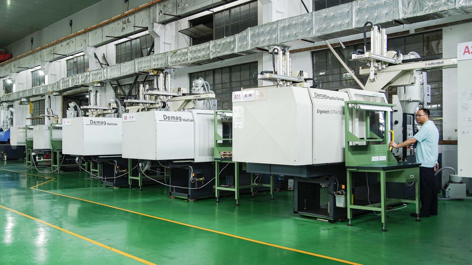 Injection molding contract manufacturing workshop with several machines in a row
